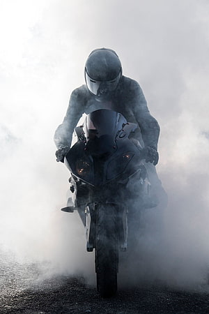 Rider on a Black BMW S1000RR Sportbike Emerging Through Thick Fog HD phone wallpaper