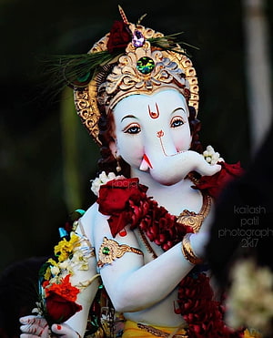 Ornate Ganesha Murti Adorned With Red Roses And Gold Crown During Ganesh Chaturthi Festival HD phone wallpaper
