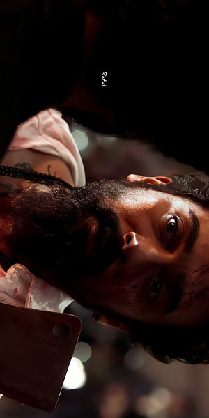 Suriya in dramatic close-up from Vikram with intense expression and dark cinematic lighting HD phone wallpaper