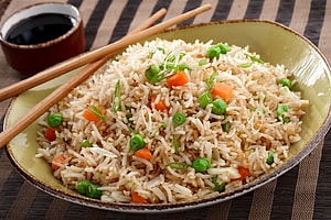 Vegetable Fried Rice with Peas and Carrots Served in a Ceramic Bowl with Chopsticks HD wallpaper