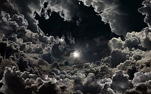 Dramatic Night Sky with Moonlight Breaking Through Dark Storm Clouds HD wallpaper
