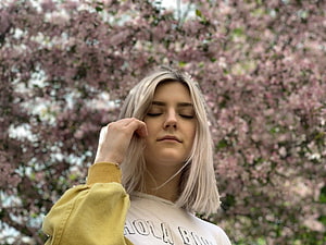 Eva Elfie Portrait Amidst Pink Cherry Blossoms in a Yellow Hoodie HD wallpaper