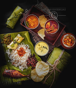 Traditional Kerala Pothichoru Meal Served on Banana Leaf with Rice and Curries HD phone wallpaper