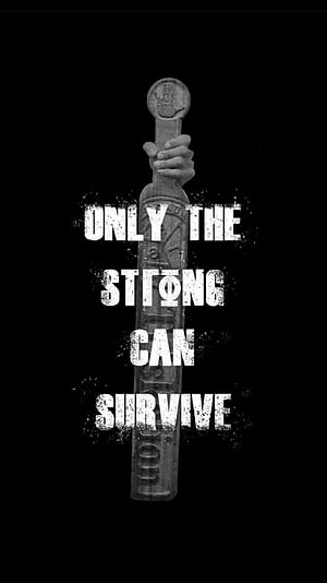Hand Gripping Stone Triskelion Totem with Motivational Quote on Black Background HD phone wallpaper