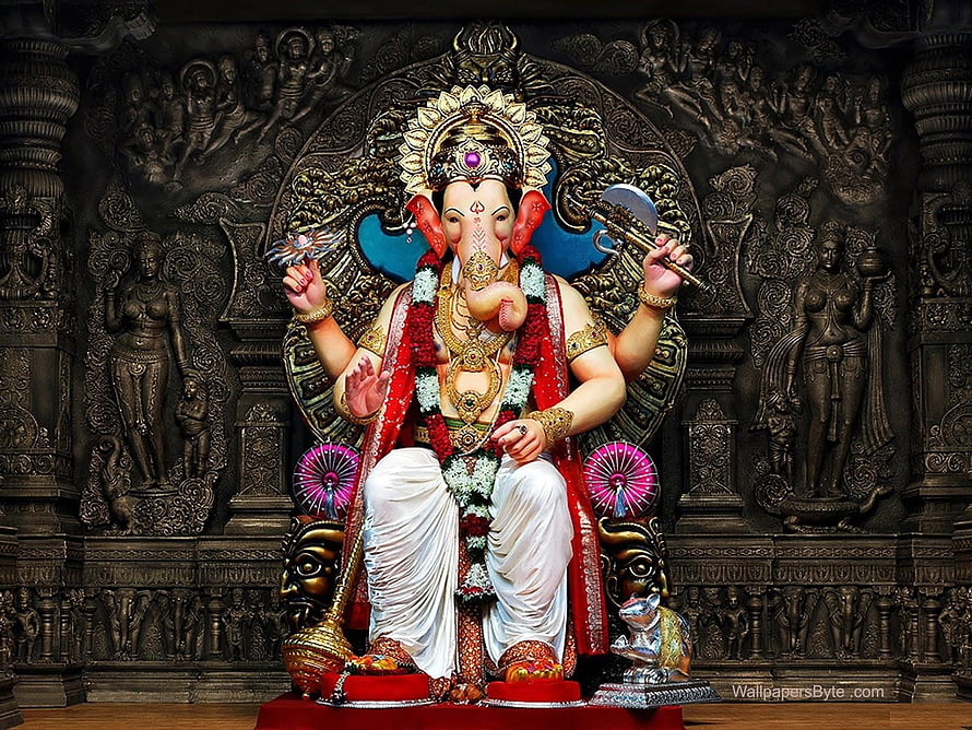 Ganesha seated on ornate throne with traditional garlands and sacred symbols in dark temple setting HD wallpaper