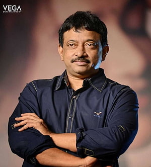 Ram Gopal Varma Portrait in Navy Blue Shirt with Arms Crossed HD phone wallpaper