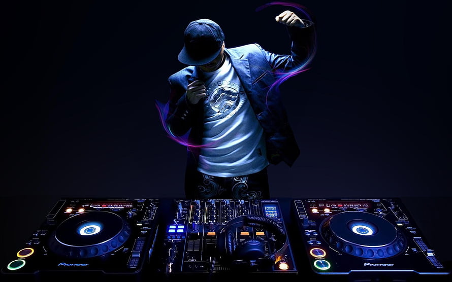 DJ performing on Pioneer turntables with neon light trails in a dark studio setting HD wallpaper
