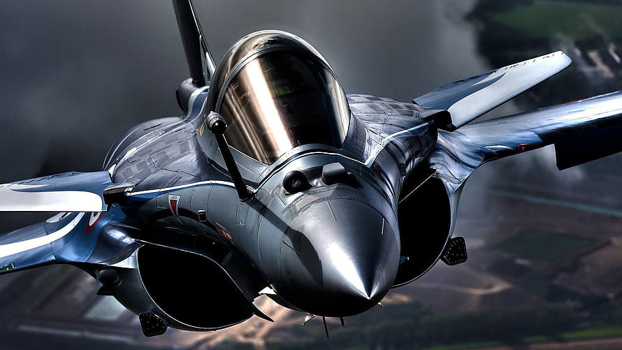 Dassault Rafale Fighter Jet Banking Through Clouds Over Rural Terrain HD wallpaper