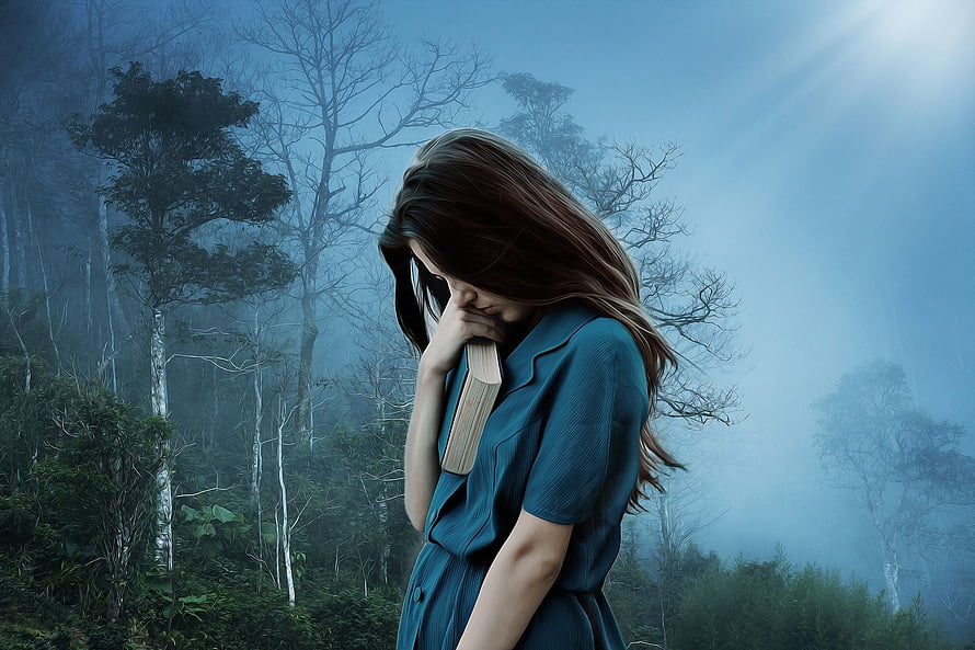 Melancholic Woman Holding Book in Misty Forest with Blue Tones HD wallpaper