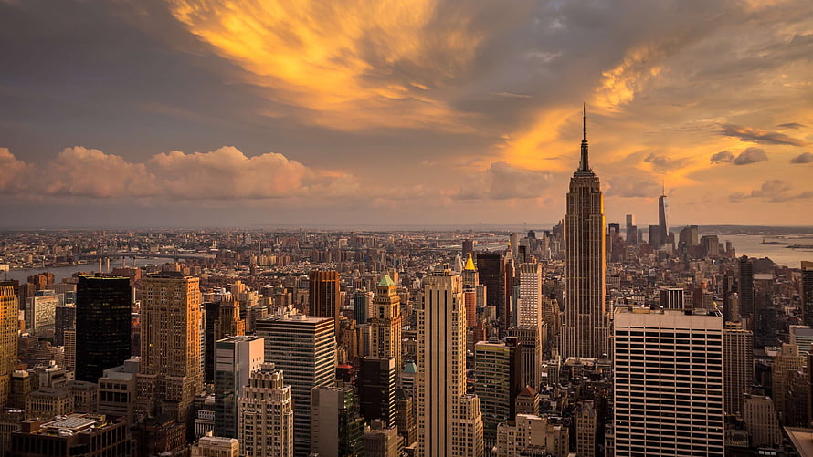 New York City Skyline at Golden Hour with Empire State Building and Dramatic Clouds HD wallpaper