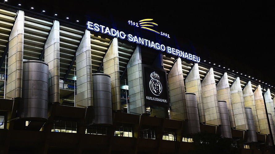 Santiago Bernabeu Stadium Exterior at Night with Real Madrid Crest and Illuminated Facade HD wallpaper