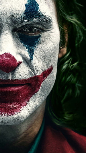 Joker Character Close-Up Portrait with White Face Paint and Green Hair HD phone wallpaper