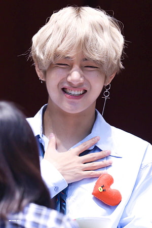 BTS V Kim Taehyung Smiling With Hand On Chest Wearing White Shirt And Heart Pin HD phone wallpaper
