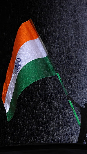 Indian National Flag Waving in Heavy Rain Against a Dark Night Sky HD phone wallpaper