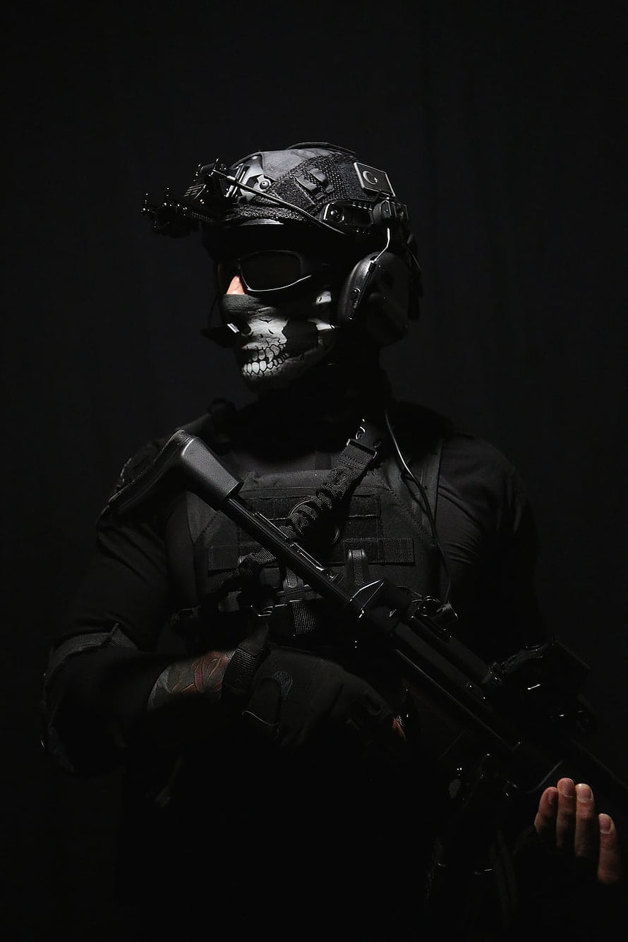Tactical Operator in Black Gear with Skull Face Paint and Assault Rifle HD phone wallpaper