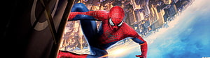 Spider-Man Swinging Over City Skyline in Classic Red and Blue Suit HD wallpaper