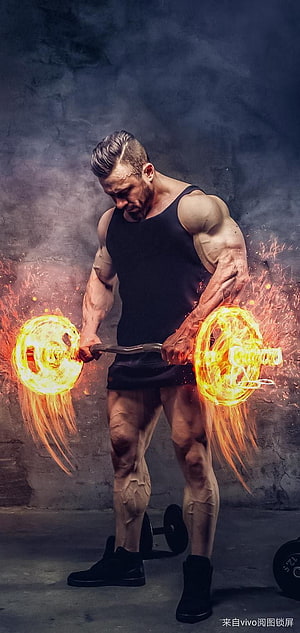 Muscular Bodybuilder Lifting a Burning Barbell in a Dark Gym Setting HD phone wallpaper