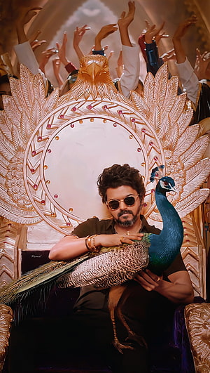 Thalapathy Vijay as Veera in Beast holding a peacock on an ornate golden throne HD phone wallpaper