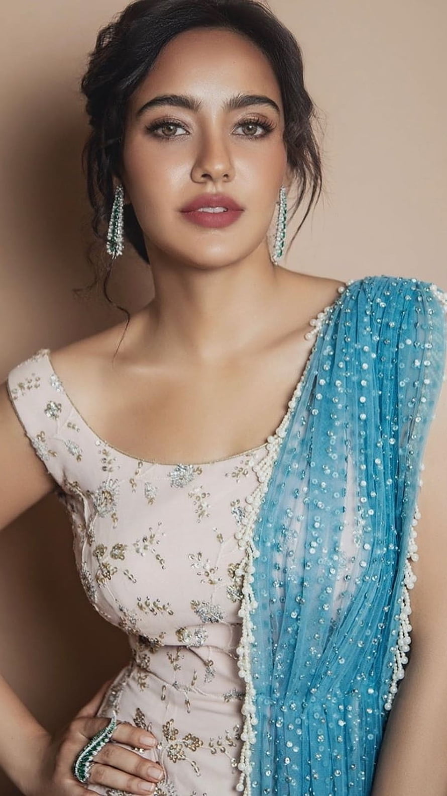Neha Sharma in an elegant pastel lehenga with a turquoise sequined dupatta and emerald jewelry HD phone wallpaper