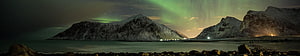 Green Aurora Borealis Dancing Over Snow-Capped Mountains and a Calm Fjord at Night HD wallpaper