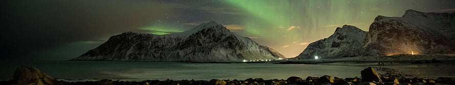 Green Aurora Borealis Dancing Over Snow-Capped Mountains and a Calm Fjord at Night HD wallpaper