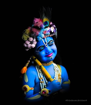 Cute Baby Krishna Idol with Peacock Feather Crown and Flute on Black Background HD phone wallpaper