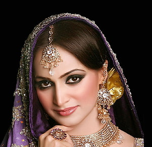 Indian Bride Portrait With Purple Dupatta, Gold Jewelry, Maang Tikka, and Bridal Makeup HD wallpaper