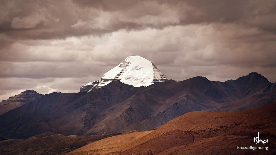 Mount Kailash Snow-Capped Peak Rising Above Arid Tibetan Plateau Under Dramatic Clouds HD wallpaper