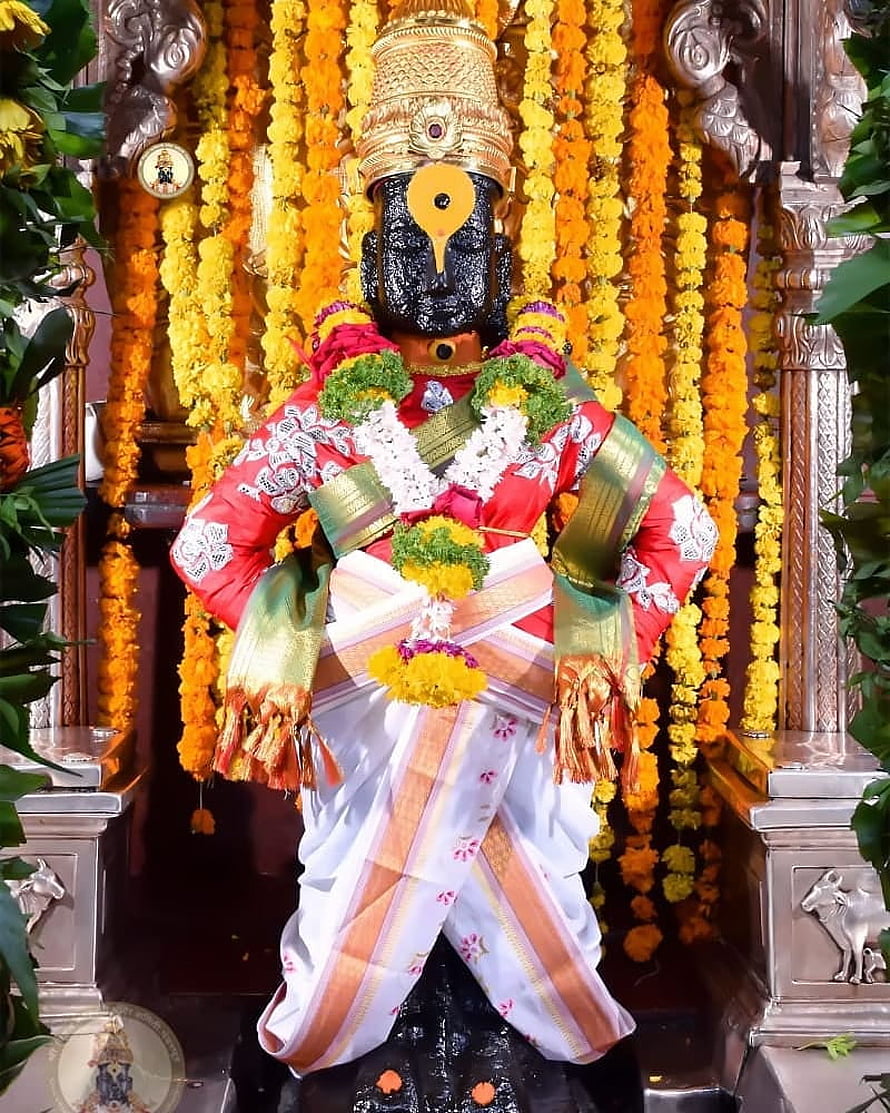 Vitthal Pandurang deity adorned in vibrant red and white traditional attire with marigold garlands HD phone wallpaper