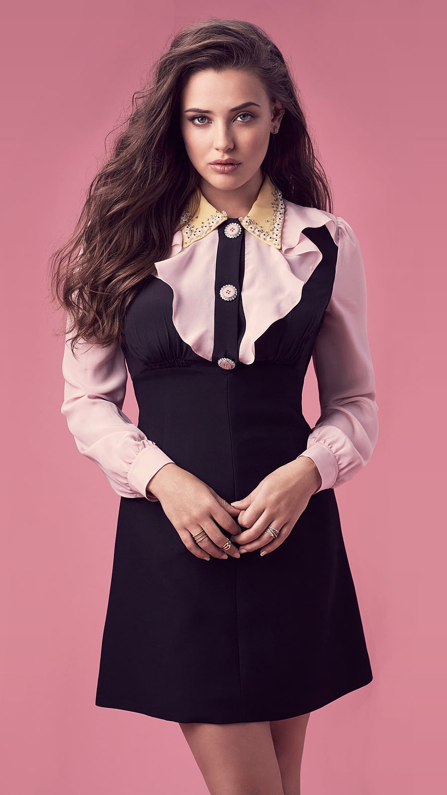 Katherine Langford in a Black and Pink Ruffled Dress Against a Pink Studio Background HD phone wallpaper