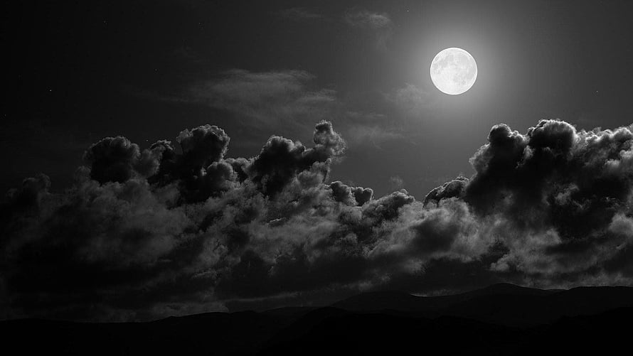 Monochrome Full Moon Rising Over Dramatic Storm Clouds and Mountain Silhouettes HD wallpaper