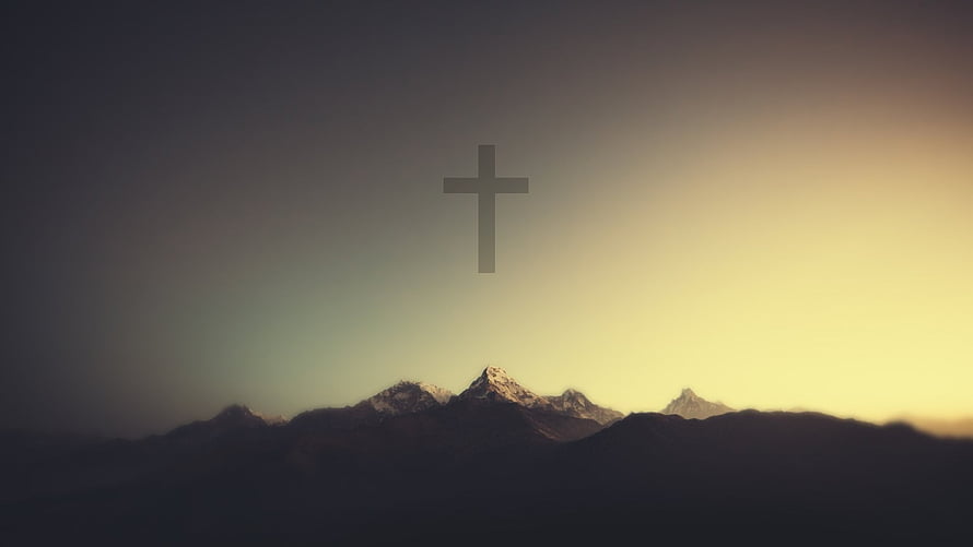 Minimalist Christian Cross Silhouette Over Snow-Capped Mountain Range at Golden Hour HD wallpaper