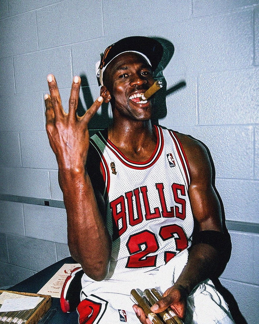 Michael Jordan in Chicago Bulls jersey holding cigars in the locker room HD phone wallpaper