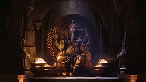 Golden Ganesha Statue Seated in Ornate Temple Niche with Burning Oil Lamps HD wallpaper