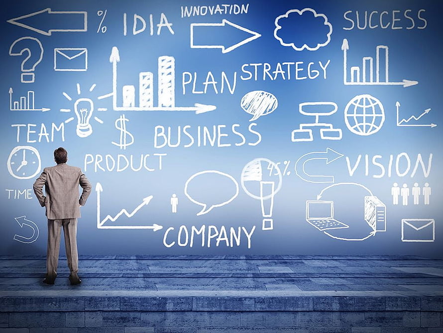 Businessman Contemplating Strategy and Innovation on a Blue Concept Wall HD wallpaper