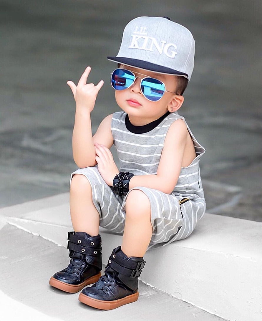 Stylish Toddler Boy in Striped Romper, Snapback Cap, and Blue Sunglasses HD phone wallpaper