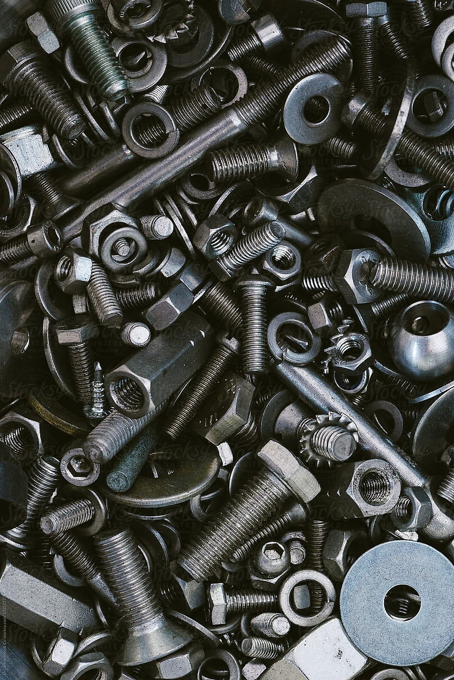 Close-up of assorted metal screws, nuts, bolts, and washers in a dense industrial pile HD phone wallpaper