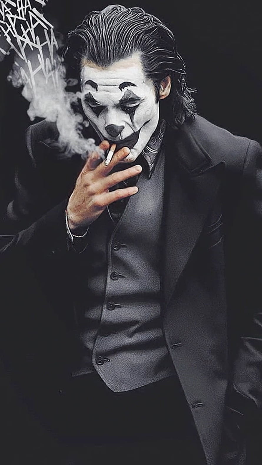 Joker in Black Suit Smoking a Cigarette with Dramatic White Face Paint HD phone wallpaper