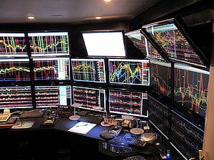 Professional Stock Trading Desk with Multiple Financial Chart Monitors and Market Data Displays HD wallpaper