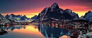 Reine Village in Lofoten Norway at Sunset with Snow-Capped Mountains and Fjord Reflections HD wallpaper