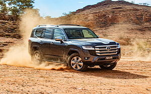 Toyota Land Cruiser 300 Sahara driving through dusty desert terrain HD wallpaper