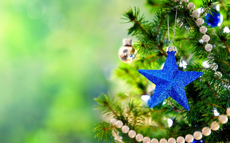 Blue Glitter Star Ornament Hanging on a Christmas Tree with Pearl Beads and Soft Green Background HD wallpaper