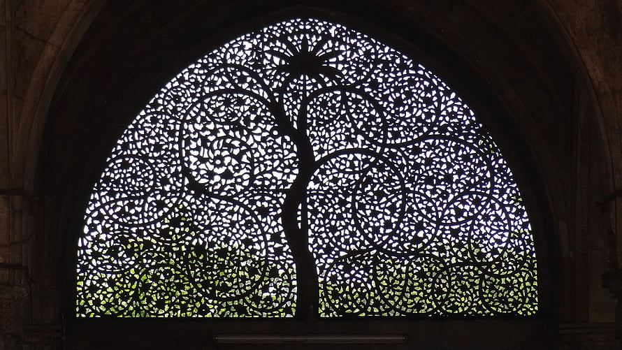 Intricate Lattice Tree Silhouette in Arched Window with Natural Light HD wallpaper