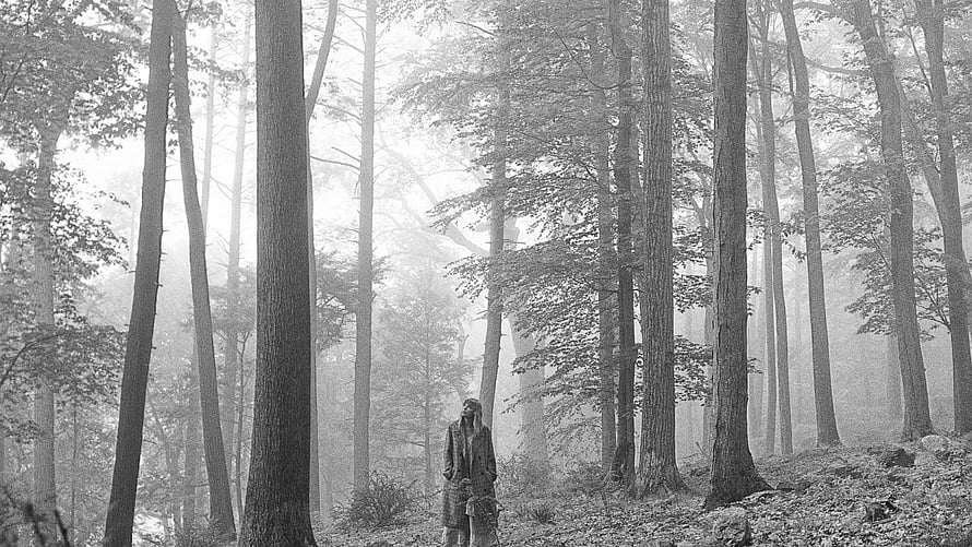 Folklore Album Artwork Featuring a Lone Figure in a Misty Black and White Forest HD wallpaper