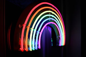 Vibrant Rainbow Neon Arch Installation Against Dark Background HD wallpaper
