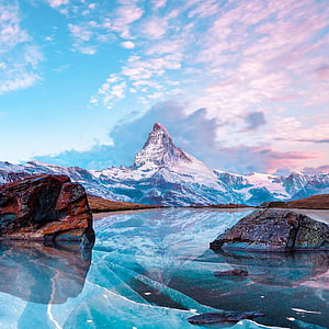 Matterhorn Peak Reflected in a Frozen Alpine Lake Under a Pastel Sky HD phone wallpaper