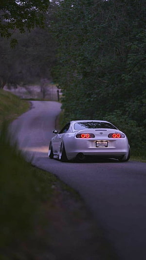 White Toyota Supra MK4 Cruising on a Winding Forest Road at Dusk HD phone wallpaper