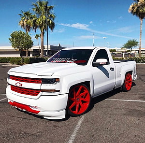 White Chevrolet Silverado Lowrider with Red Wheels and Custom Grille HD wallpaper