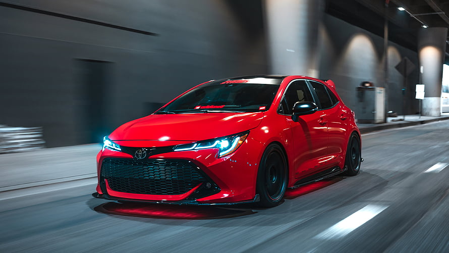 Red Toyota Corolla Gr Sport Hatchback Driving Through Urban Tunnel At Night HD wallpaper