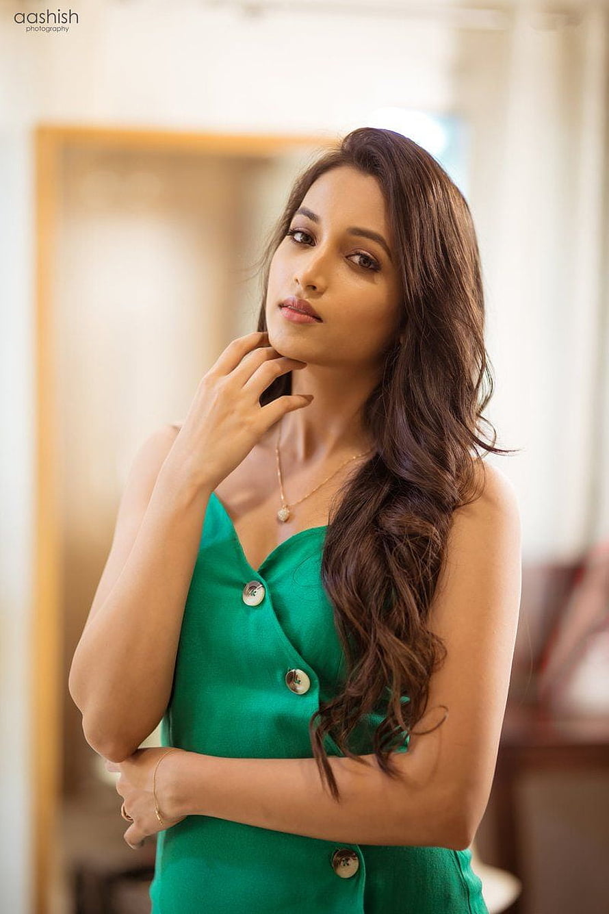 Srinidhi Shetty in a Green Dress with Long Wavy Hair and Gold Necklace HD phone wallpaper